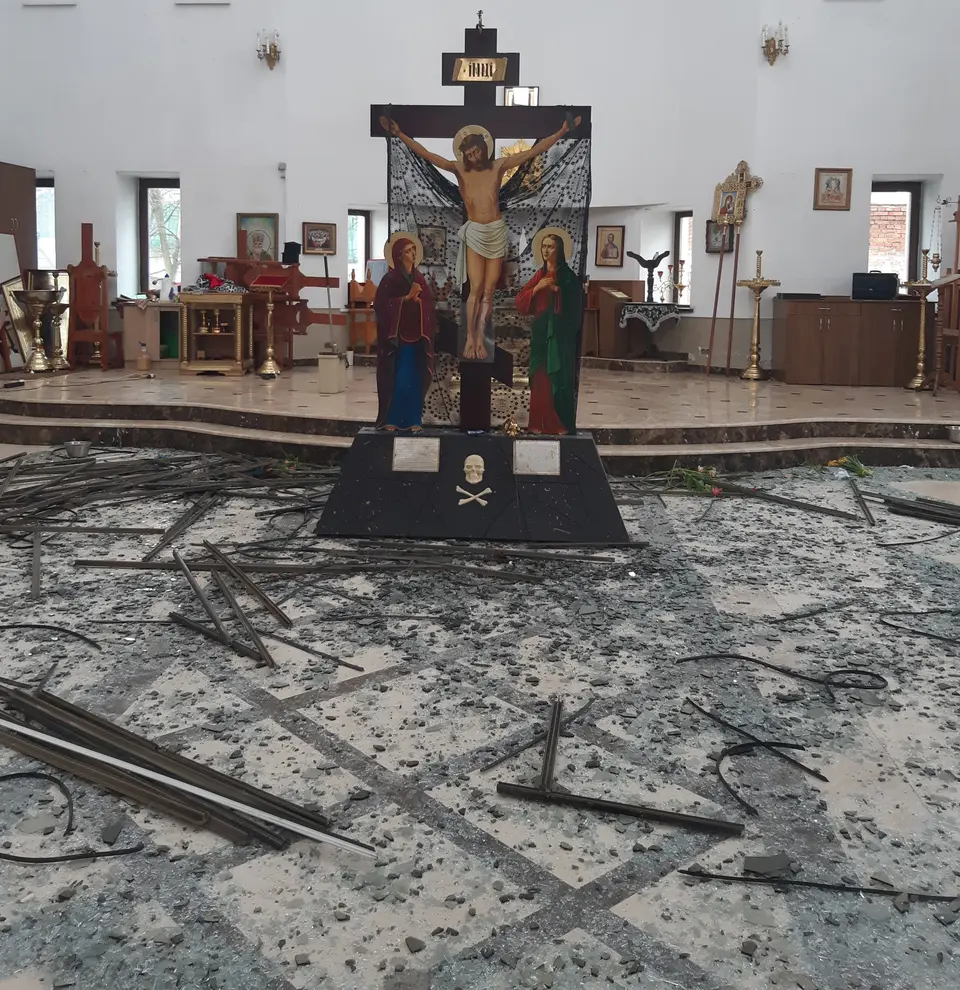 Debris and fallen metal window frames on the floor inside a church in Kyiv.