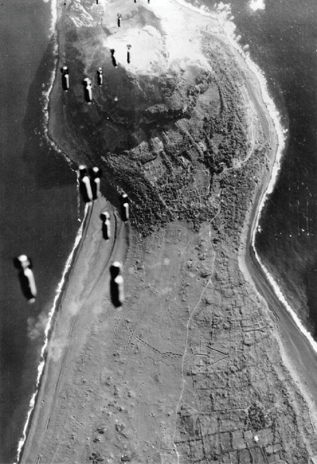 Black-and-white aerial view of a beach with vessels along the shore, supplied as Iwo Jima historical imagery.